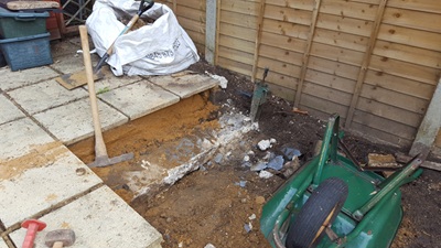Additional space cleared, removing footings from previous patio