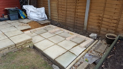 First bricks being arranged on top of completed paved base