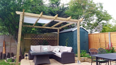 Completed pergola with sofa and firepit table